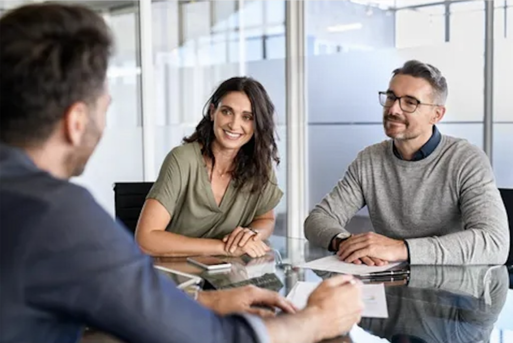 A friendly advisor-style meeting in a bright office—how WealthChief partners with you on your money.